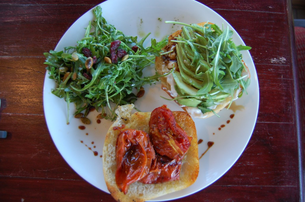 Avocado Sandwich on Grilled Ciabatta with Roasted Tomato, Pomegranate, Vegenaise, and Arugula